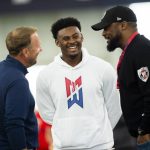 
              FILE - Malik Willis, center, talks with Liberty head coach Hugh Freeze, left, and Pittsburgh Steelers head coach Mike Tomlin during Liberty football Pro Day in Lynchburg, Va., Tuesday, March 22, 2022. Carolina is likely to have its choice of the top three quarterbacks in the draft at No. 6 — Liberty’s Malik Willis, Pittsburgh’s Kenny Pickett and Mississippi’s Matt Corral — but there is plenty of debate as to whether any of them are worthy of being top 10 picks. (AP Photo/Kendall Warner)
            