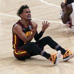 
              Atlanta Hawks guard Trae Young, left, reacts after being charged with a foul in the first half of an NBA playoff basketball game against the Miami Heat, Sunday, April 24, 2022, in Atlanta. (AP Photo/John Bazemore)
            