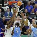 
              Kansas forward Mitch Lightfoot (44) and North Carolina forward Armando Bacot (5) vie for a rebound during the first half of a college basketball game in the finals of the Men's Final Four NCAA tournament, Monday, April 4, 2022, in New Orleans. (AP Photo/Gerald Herbert)
            
