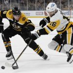 
              Pittsburgh Penguins' Jason Zucker shoots past Boston Bruins defenseman Mike Reilly during the third period of an NHL hockey game Saturday, April 16, 2022, in Boston. (AP Photo/Winslow Townson)
            
