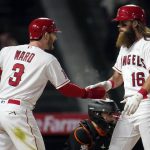 
              Los Angeles Angels' Brandon Marsh (16) celebrates his two-run home run with Taylor Ward (3) during the sixth inning of the team's baseball game against the Baltimore Orioles on Saturday, April 23, 2022, in Anaheim, Calif. (AP Photo/Marcio Jose Sanchez)
            