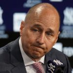 
              Brian Cashman, general manager and senior vice president of the New York Yankees, announces that the team failed to secure a multi-year deal with right fielder Aaron Judge (99) before their opening day baseball game against the Boston Red Sox, Friday, April 8, 2022, in New York. (AP Photo/John Minchillo)
            