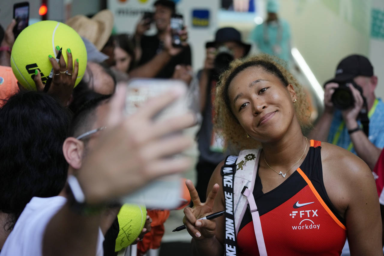 Naomi Osaka of Japan poses for selfies with fans after winning her women's semifinal match against ...