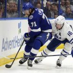 
              Tampa Bay Lightning center Anthony Cirelli (71) controls the puck in front of Toronto Maple Leafs right wing Mitchell Marner (16) during the second period of an NHL hockey game Thursday, April 21, 2022, in Tampa, Fla. (AP Photo/Chris O'Meara)
            