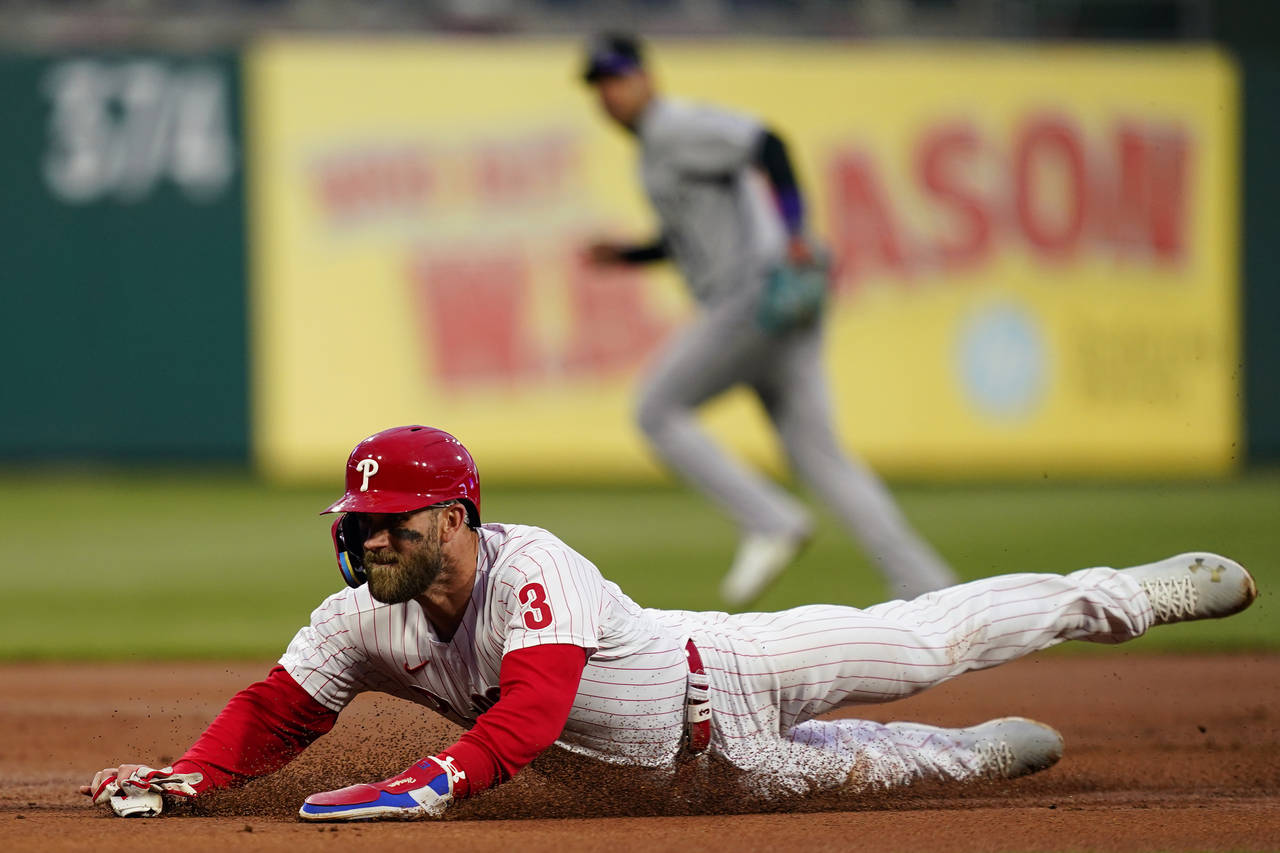 Philadelphia Phillies' Bryce Harper steals third base during the first inning of a baseball game ag...