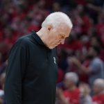 
              San Antonio Spurs head coach Gregg Popovich walks on the court during a timeout in the first half of an NBA play-in basketball game against the New Orleans Pelicans in New Orleans, Wednesday, April 13, 2022. (AP Photo/Gerald Herbert)
            