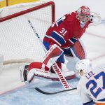 
              New York Islanders' Anders Lee (27) shoots against Montreal Canadiens goaltender Carey Price (31) during second-period NHL hockey game action in Montreal, Friday, April 15, 2022. (Graham Hughes/The Canadian Press via AP)
            