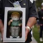 
              Dan Szatkowski, North Augusta, S.C, poses with his newly purchased garden gnome during a practice round for the Masters golf tournament on Tuesday, April 5, 2022, in Augusta, Ga. (AP Photo/Robert F. Bukaty)
            