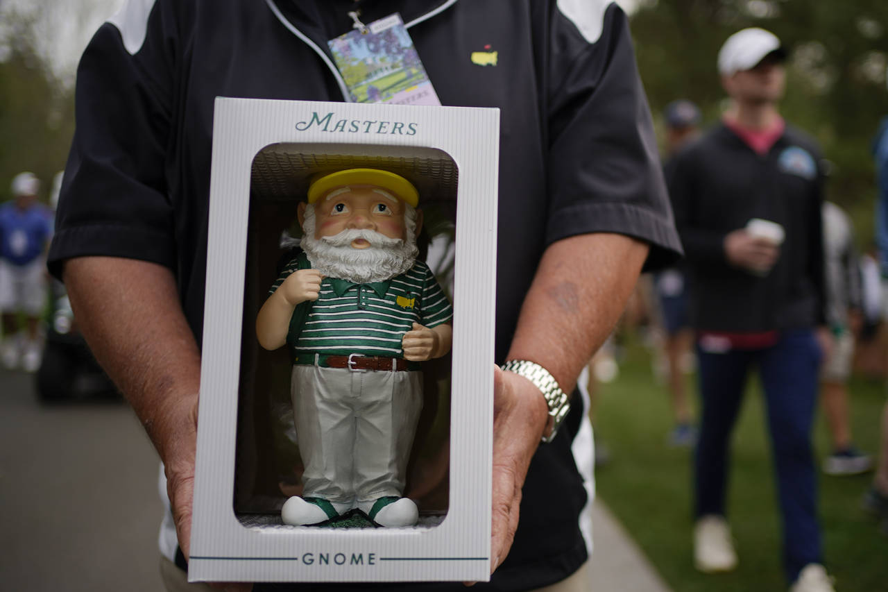 Dan Szatkowski, North Augusta, S.C, poses with his newly purchased garden gnome during a practice r...