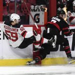 
              New Jersey Devils center Janne Kuokkanen (59) is checked into the boards by Ottawa Senators left wing Brady Tkachuk (7) during the second period of an NHL hockey game in Ottawa, on Tuesday, April 26, 2022. (Justin Tang/The Canadian Press via AP)
            