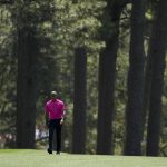 
              Tiger Woods walks down the eighth fairway during the first round at the Masters golf tournament on Thursday, April 7, 2022, in Augusta, Ga. (AP Photo/Charlie Riedel)
            