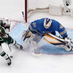 
              Minnesota Wild's Kirill Kaprizov, left, is unable to score past St. Louis Blues goaltender Ville Husso during the second period of an NHL hockey game Saturday, April 16, 2022, in St. Louis. (AP Photo/Jeff Roberson)
            
