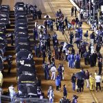 
              Cars sit under covers and drivers stand along side of them on pit road during a rain delay in a NASCAR Cup Series auto race, late Sunday, April 17, 2022, in Bristol, Tenn. (AP Photo/Wade Payne)
            
