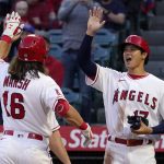 
              Los Angeles Angels' Brandon Marsh, left, is congratulated by Shohei Ohtani, right, and Max Stassi after hitting a three-run home run during the first inning of a baseball game Monday, April 11, 2022, in Anaheim, Calif. (AP Photo/Mark J. Terrill)
            