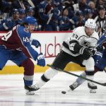 
              Los Angeles Kings left wing Viktor Arvidsson, center, fights for control of the puck with Colorado Avalanche defenseman Samuel Girard, left, and right wing Valeri Nichushkin during the second period of an NHL hockey game Wednesday, April 13, 2022, in Denver. (AP Photo/David Zalubowski)
            