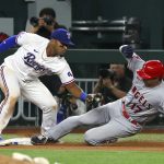 
              Texas Rangers third baseman Andy Ibanez (77) is late with the tag as Los Angeles Angels designated hitter Shohei Ohtani (17) steals third in the seventh inning during a baseball game on Saturday, April 16, 2022, in Arlington, Texas. (AP Photo/Richard W. Rodriguez)
            