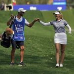
              Jessica Korda bumps fists with her caddie after making an eagle from the fairway on the third hole during the final round of the LPGA Chevron Championship golf tournament Sunday, April 3, 2022, in Rancho Mirage, Calif. (AP Photo/Marcio Jose Sanchez)
            