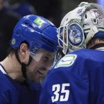 
              Vancouver Canucks' Luke Schenn, left, and goalie Thatcher Demko celebrate the team's win over the San Jose Sharks in an NHL hockey game Saturday, April 9, 2022, in Vancouver, British Columbia. (Darryl Dyck/The Canadian Press via AP)
            