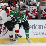 
              New Jersey Devils defenseman Kevin Bahl (88) gets pushed from the puck by Dallas Stars center Luke Glendening (11) during the first period of an NHL hockey game in Dallas, Saturday, April 9, 2022. (AP Photo/Michael Ainsworth)
            