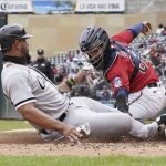 
              Chicago White Sox's Jose Abreu, left, is tagged out by Minnesota Twins catcher Jose Godoy while trying to score on a hit by Andrew Vaughn in the third inning of a baseball game, Sunday, April 24, 2022, in Minneapolis. (AP Photo/Jim Mone)
            