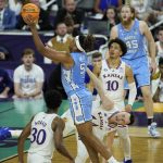 
              North Carolina forward Armando Bacot (5) shoots against Kansas forward Mitch Lightfoot during the first half of a college basketball game in the finals of the Men's Final Four NCAA tournament, Monday, April 4, 2022, in New Orleans. (AP Photo/Gerald Herbert)
            