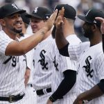 Chicago White Sox's Jose Abreu, left, greets teammates as he runs on the field during an opening day baseball game against the Seattle Mariners in Chicago, Tuesday, April 12, 2022. (AP Photo/Nam Y. Huh)