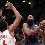 
              Philadelphia 76ers guard James Harden (1) drives to the net under pressure from Toronto Raptors forward Scottie Barnes (4) during the second half of Game 6 of an NBA basketball first-round playoff series in Toronto, Thursday, April 28, 2022. (Frank Gunn/The Canadian Press via AP)
            