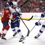 
              Florida Panthers center Sam Reinhart (13), Tampa Bay Lightning left wing Brandon Hagel (38) and defenseman Ryan McDonagh (27) go for the puck during the second period of an NHL hockey game, Sunday, April 24, 2022, in Sunrise, Fla. (AP Photo/Lynne Sladky)
            