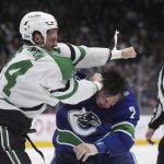 
              Dallas Stars' Jamie Benn, left, and Vancouver Canucks' Luke Schenn fight during the second period of an NHL hockey game in Vancouver, British Columbia, Monday, April 18, 2022. (Darryl Dyck/The Canadian Press via AP)
            