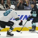 
              Seattle Kraken center Yanni Gourde (37) looks to pass against San Jose Sharks defenseman Mario Ferraro (38) during the first period of an NHL hockey game, Friday, April 29, 2022, in Seattle. (AP Photo/Ted S. Warren)
            