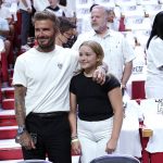 
              David Beckham stands with his daughter Harper Seven Beckham during the first half of Game 2 of an NBA basketball first-round playoff series between the Miami Heat and Atlanta Hawks, Tuesday, April 19, 2022, in Miami. (AP Photo/Lynne Sladky)
            