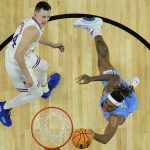 
              North Carolina forward Armando Bacot, right, shoots against Kansas forward Mitch Lightfoot (44) during the first half of a college basketball game in the finals of the Men's Final Four NCAA tournament, Monday, April 4, 2022, in New Orleans. (AP Photo/Brynn Anderson)
            