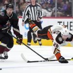
              Anaheim Ducks center Gerry Mayhew (26) get sent to the ice by Arizona Coyotes left wing Michael Carcone during the first period of an NHL hockey game Friday, April 1, 2022, in Glendale, Ariz. (AP Photo/Rick Scuteri)
            