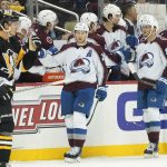 
              Colorado Avalanche's Nathan MacKinnon, center, celebrates with teammates on the bench after scoring against the Pittsburgh Penguins during the second period of an NHL hockey game, Tuesday, April 5, 2022, in Pittsburgh. (AP Photo/Keith Srakocic)
            
