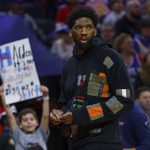 
              Philadelphia 76ers' Joel Embiid looks on as he has the night off during the first half of an NBA basketball game against the Detroit Pistons, Sunday, April 10, 2022, in Philadelphia. (AP Photo/Chris Szagola)
            
