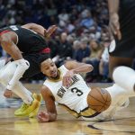 
              New Orleans Pelicans guard CJ McCollum (3) battles for a loose ball against Portland Trail Blazers guard Brandon Williams in the second half of an NBA basketball game in New Orleans, Thursday, April 7, 2022. (AP Photo/Gerald Herbert)
            