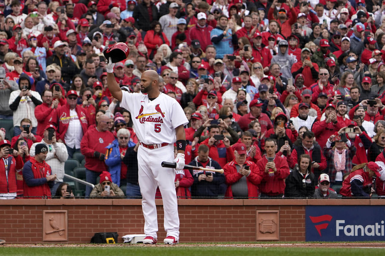 St. Louis Cardinals designated hitter Albert Pujols tips his cap as he steps up to bat during the f...