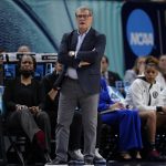 
              UConn head coach Geno Auriemma watches during the first half of a college basketball game in the semifinal round of the Women's Final Four NCAA tournament Friday, April 1, 2022, in Minneapolis. (AP Photo/Charlie Neibergall)
            