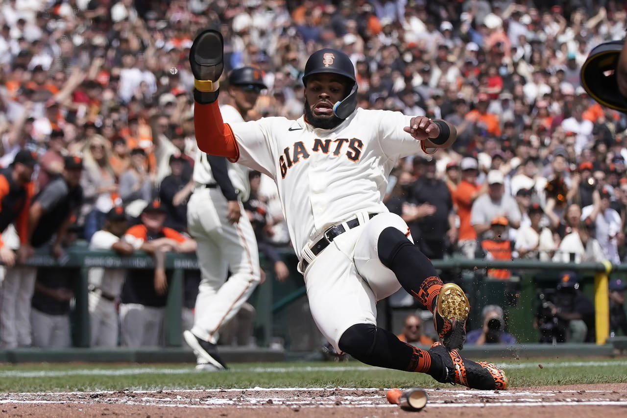 San Francisco Giants' Heliot Ramos slides home to score during the second inning of a baseball game...