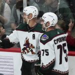 
              Arizona Coyotes' Anton Stralman, left, and Kyle Capobianco (75) celebrate Stralman's goal off Minnesota Wild goalie March-Andre Fleury in the second period of an NHL hockey game, Tuesday, April 26, 2022, in St. Paul, Minn. (AP Photo/Jim Mone)
            