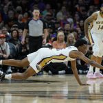 
              New Orleans Pelicans forward Herbert Jones grabs the loose ball against the Phoenix Suns during the second half of Game 2 of an NBA basketball first-round playoff series, Tuesday, April 19, 2022, in Phoenix. (AP Photo/Matt York)
            