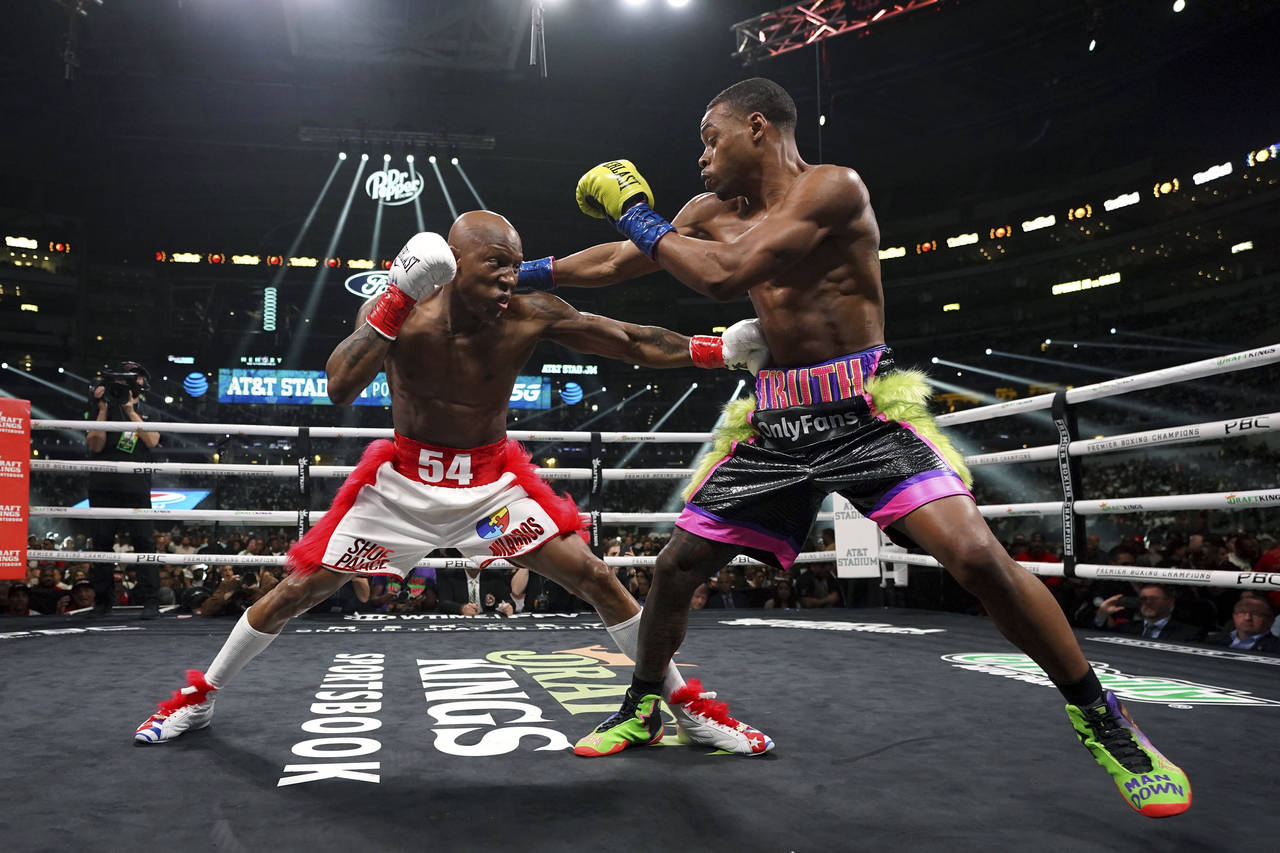 Errol Spence Jr., right, and Yordenis Ugas, from Cuba, trade punches during a welterweight champion...