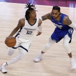 
              Memphis Grizzlies guard Ja Morant (12) drives around Minnesota Timberwolves guard D'Angelo Russell (0) during the first half in Game 6 of an NBA basketball first-round playoff series Friday, April 29, 2022, in Minneapolis. (AP Photo/Andy Clayton-King)
            