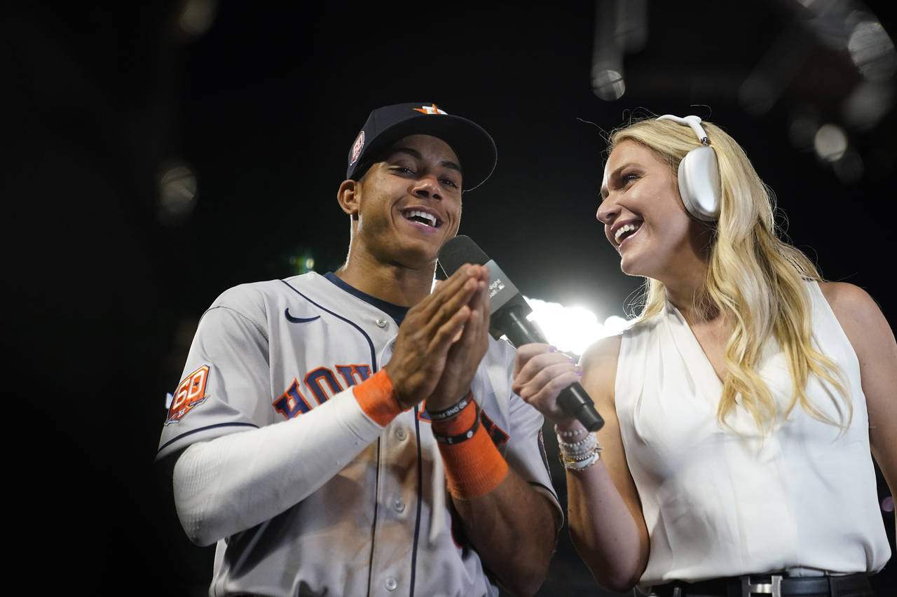 Houston Astros' Jeremy Pena, left, takes part in an interview after the team's 13-6 win over the Lo...