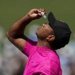 
              Tiger Woods uses eye drops on the seventh green during the first round at the Masters golf tournament on Thursday, April 7, 2022, in Augusta, Ga. (AP Photo/David J. Phillip)
            