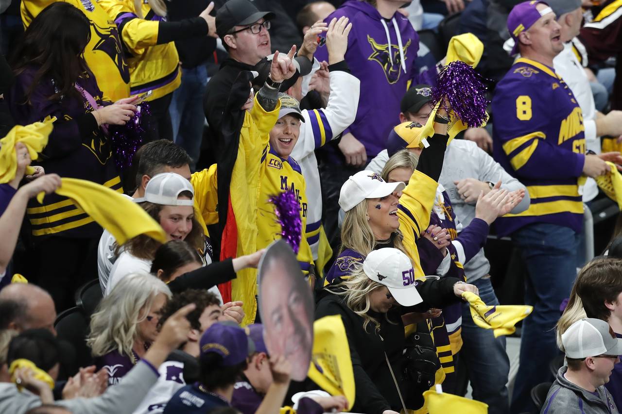 Minnesota State fans celebrate a goal by David Silye against Minnesota during the third period of a...