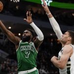 
              Boston Celtics' Jaylen Brown shoots past Milwaukee Bucks' Brook Lopez during the second half of an NBA basketball game Thursday, April 7, 2022, in Milwaukee. The Bucks won 127-121. (AP Photo/Morry Gash)
            