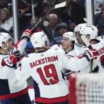 
              Washington Capitals left wing Alex Ovechkin (8) is congratulated by teammates after scoring a goal against the Colorado Avalanche during the second period of an NHL hockey game Monday, April 18, 2022, in Denver. (AP Photo/Jack Dempsey)
            