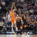 
              Utah Jazz forward Royce O'Neale (23) fouls Phoenix Suns guard Devin Booker (1) during the first half of an NBA basketball game Friday, April 8, 2022, in Salt Lake City. (AP Photo/Rick Bowmer)
            
