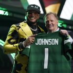 
              Florida State Defensive end Jermaine Johnson II stands with NFL Commissioner Roger Goodell after being chosen by the New York Jets with the 26th pick of the NFL football draft Thursday, April 28, 2022, in Las Vegas. (AP Photo/John Locher)
            